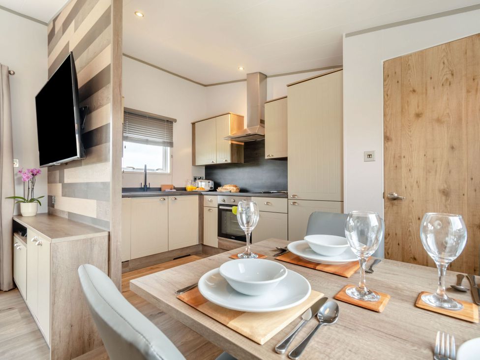 A kitchen with dining table setup at Kinder Spa in Carlton Miniott near Thirsk