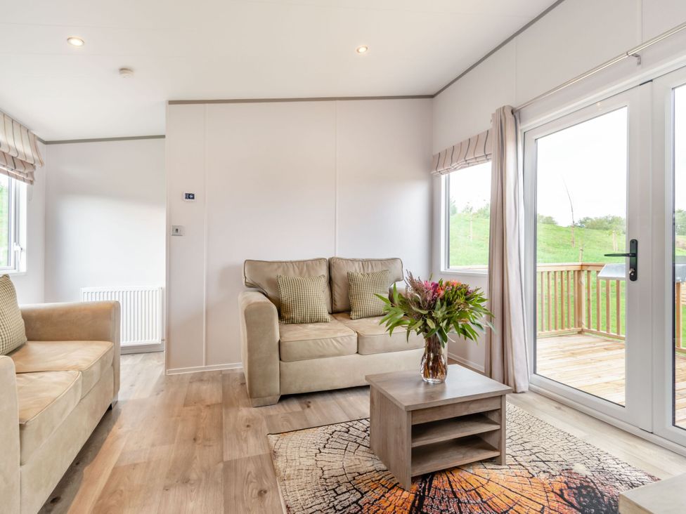 A living room with a sofa and coffee table at Kinder Spa (Pet) Carlton Miniott near Thirsk