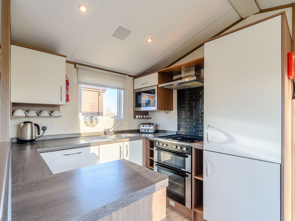A kitchen with modern appliances and cabinetry at Alder Spa (Pet) Carlton Miniott near Thirsk