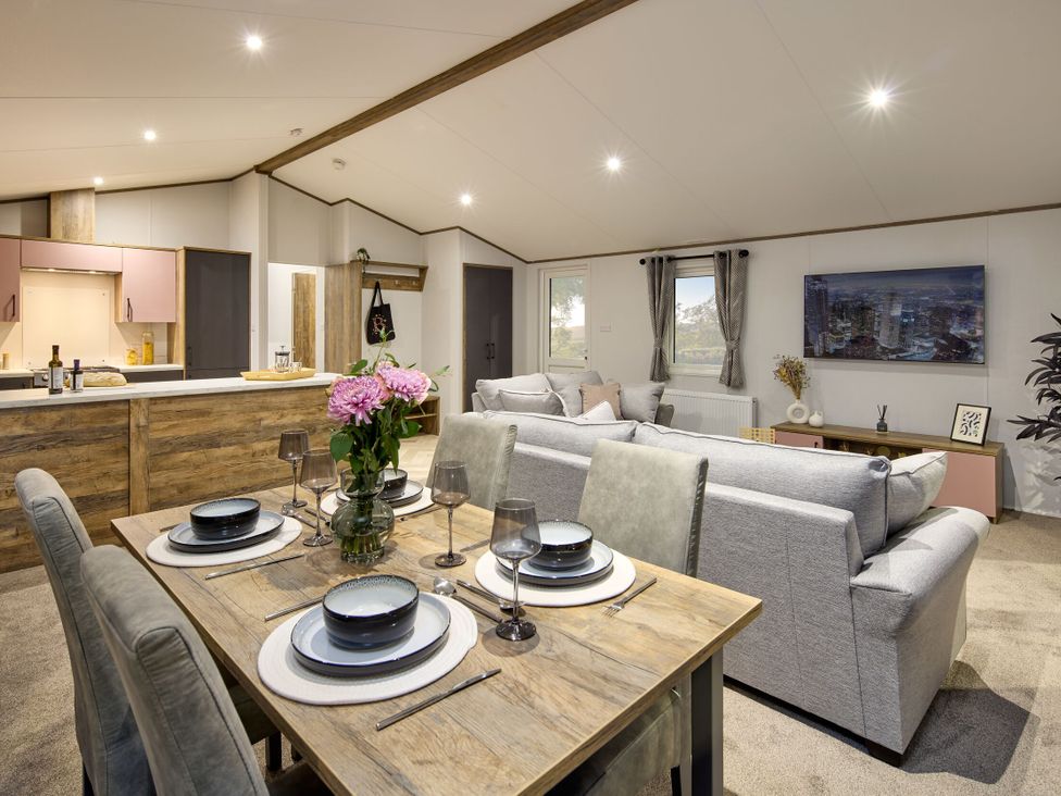 A living room with a dining table and sofa at Laurel Spa in Carlton Miniott near Thirsk