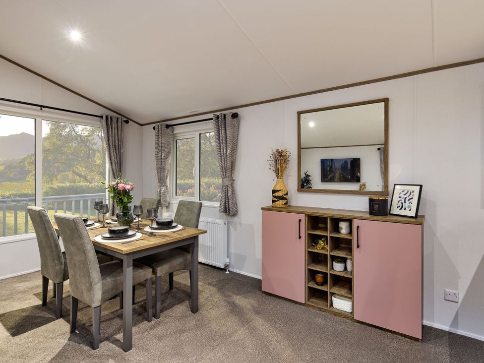 A dining room with a table and chairs at Laurel Spa Carlton Miniott near Thirsk