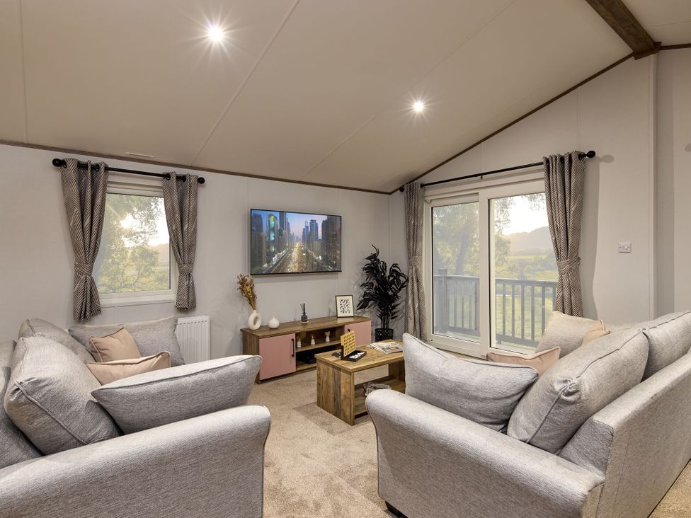 A living room with a sofa and television at Laurel Spa in Carlton Miniott near Thirsk