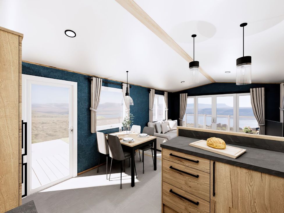 A kitchen with a dining table and sofa at Willow Spa (Pet) Carlton Miniott near Thirsk