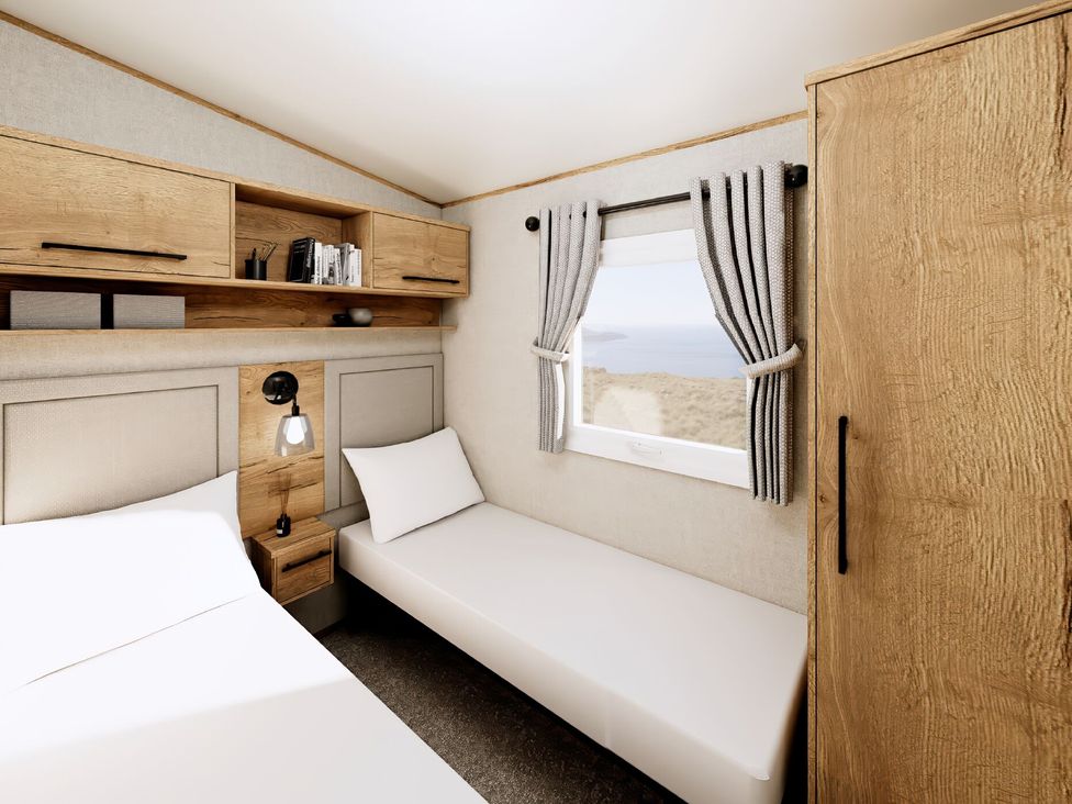 A bedroom with a bed, nightstand, and window at Willow Spa (Pet) Carlton Miniott near Thirsk