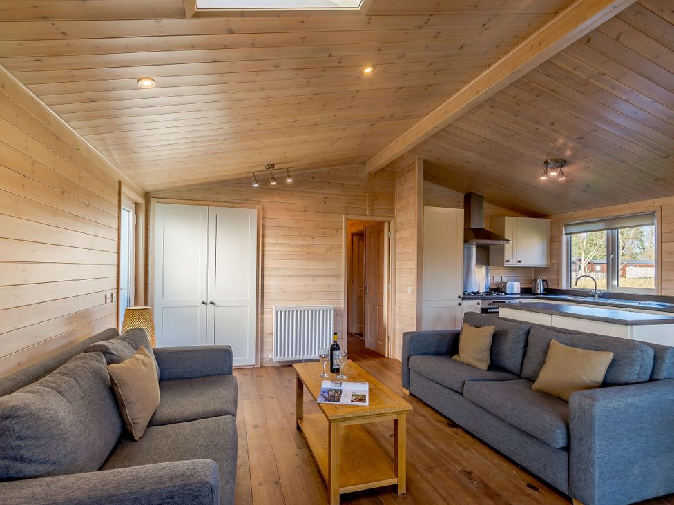 A living room with sofas and a coffee table at Fir Tree Waterside Spa in Carlton Miniott near Thirsk