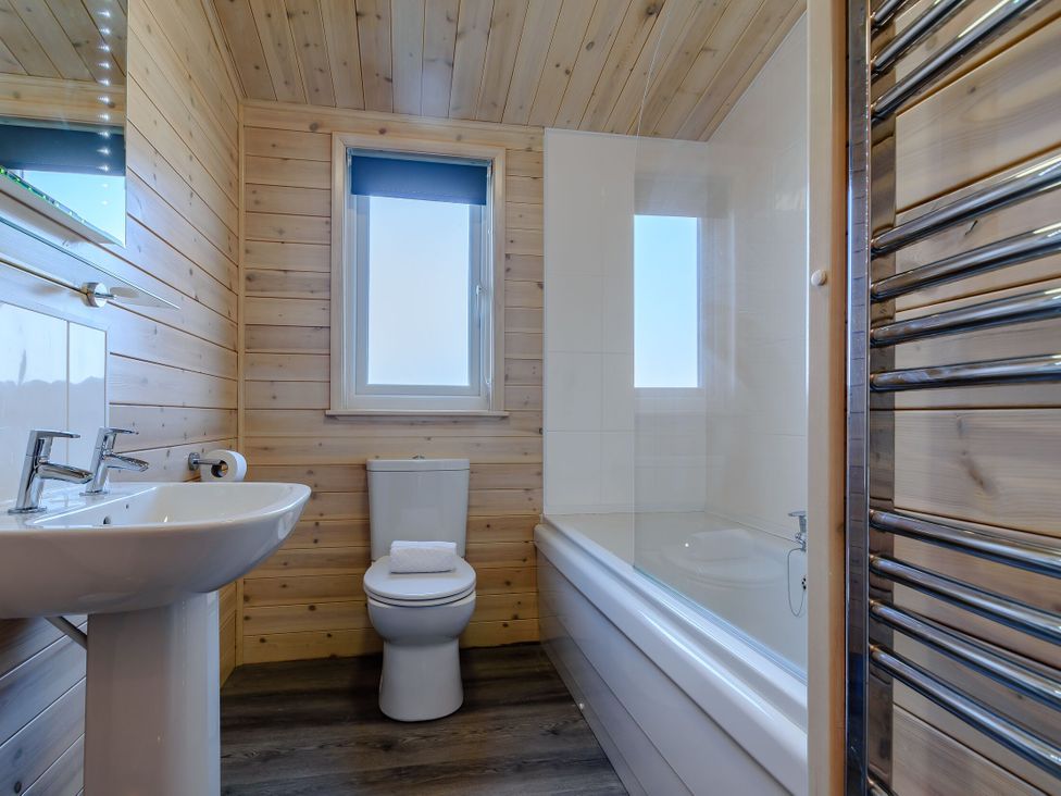 A bathroom with a sink, toilet and bathtub at Fir Tree Waterside Spa Carlton Miniott near Thirsk