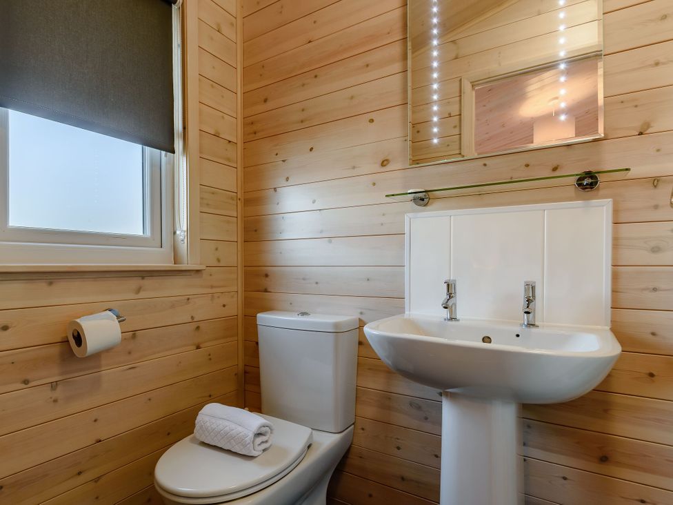 A bathroom with sink and toilet at Fir Tree Waterside Spa Carlton Miniott near Thirsk