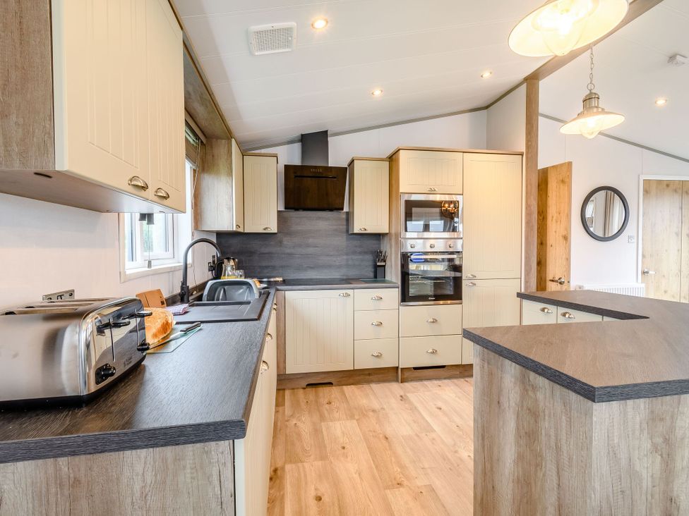 A kitchen with a sink and toaster at Spindle Spa Carlton Miniott near Thirsk