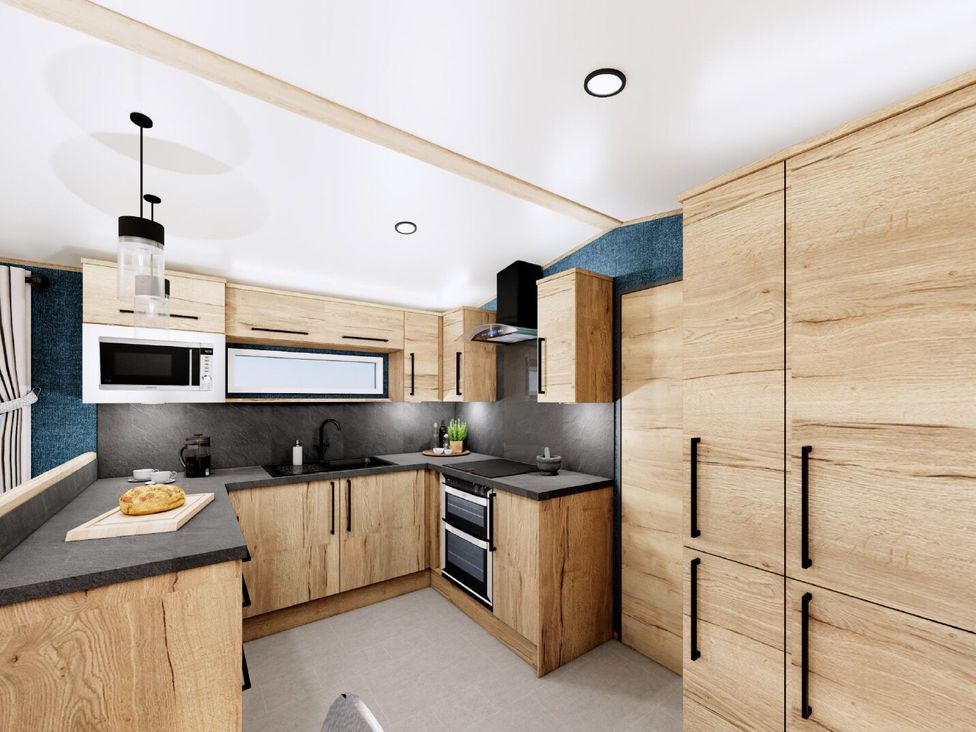 A kitchen with cabinets and appliances at Oak Spa (Pet) Carlton Miniott near Thirsk