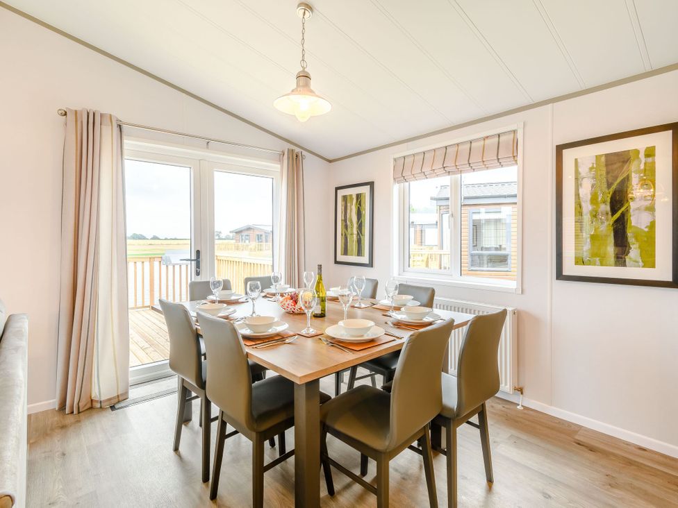 A dining room with a table set for dinner at Beech Waterside Spa (Pet) Carlton Miniott near Thirsk