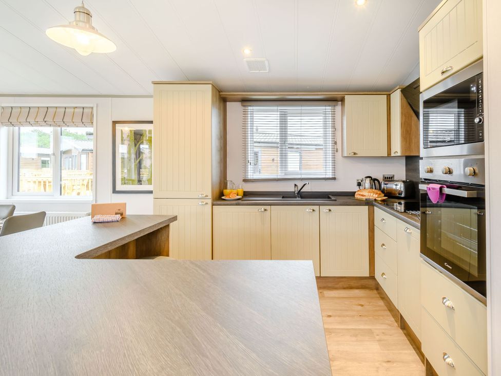 A kitchen with appliances and a countertop at Beech Waterside Spa (Pet) Carlton Miniott near Thirsk