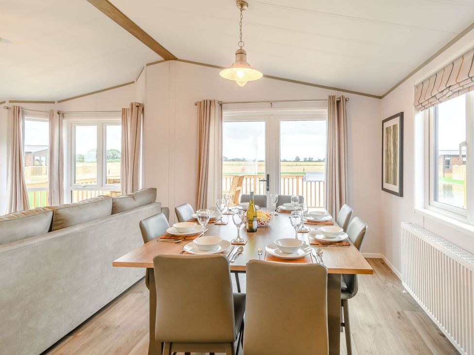 A dining room with a table and chairs at Beech Waterside Spa (Pet) Carlton Miniott near Thirsk