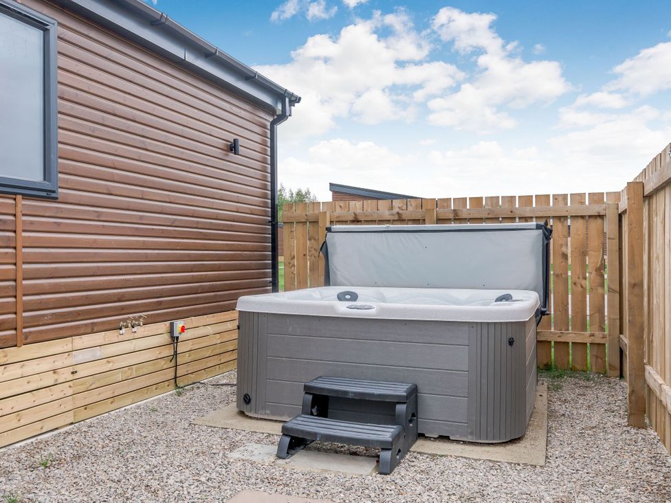 An outdoor area with a hot tub and steps at Beech Waterside Spa (Pet) Carlton Miniott near Thirsk