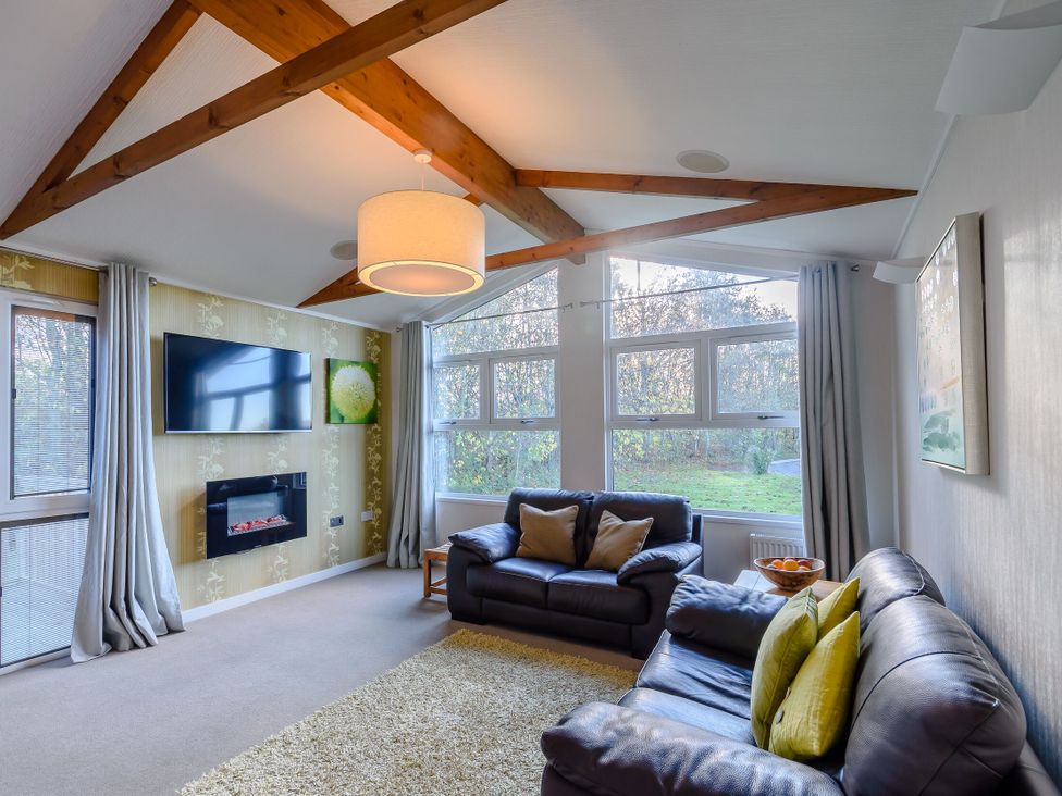 A living room with sofa and television at Cherry Tree in Carlton Miniott near Thirsk