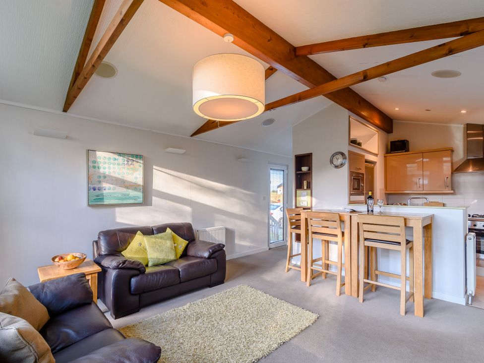 A living room with a sofa and dining area at Cherry Tree Carlton Miniott near Thirsk