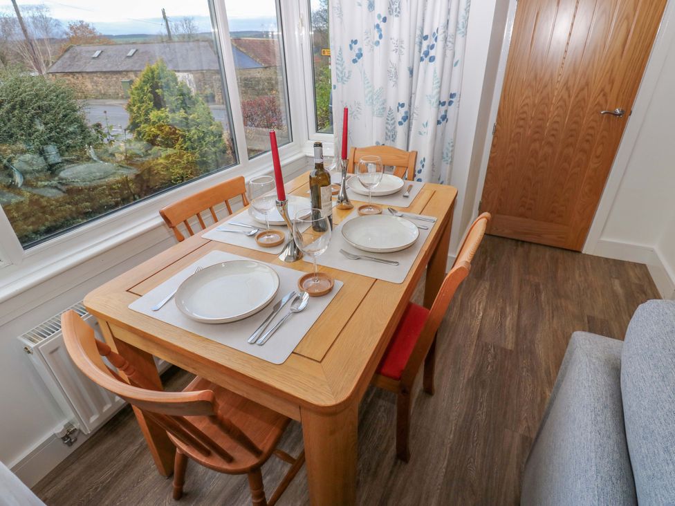A dining table set for a meal at Mains Cottage in Consett