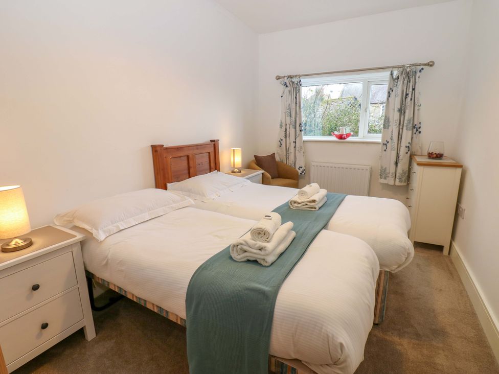 A bedroom with twin beds and a window at Mains Cottage in Consett