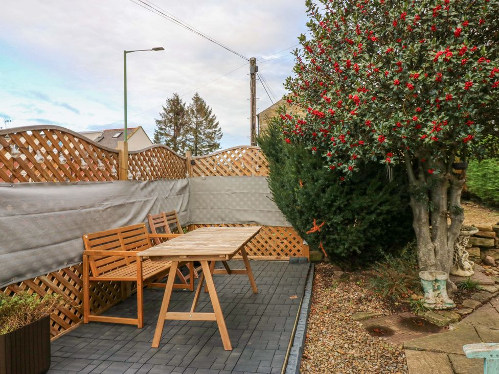 A garden seating area with a table and chairs at Mains Cottage in Consett