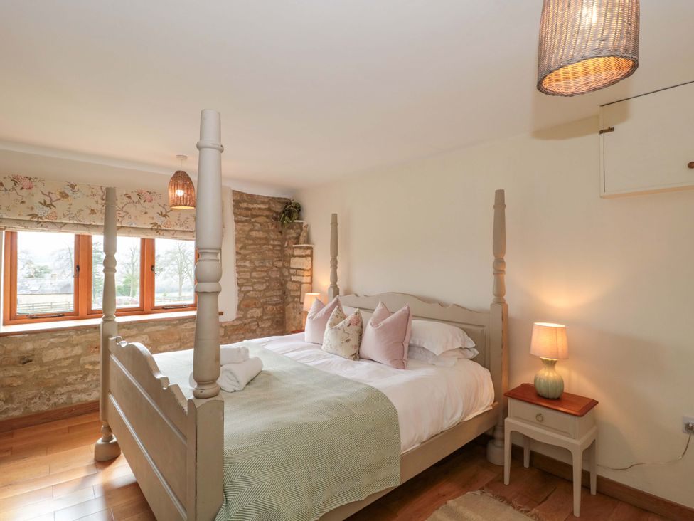 A bedroom with a bed and lamp at Daisy Bank in Maugersbury near Stow-On-The-Wold
