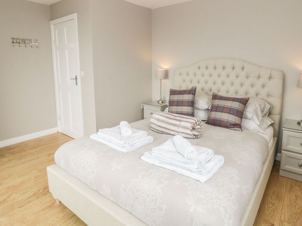 A bedroom with a bed and side tables at Dunholme
