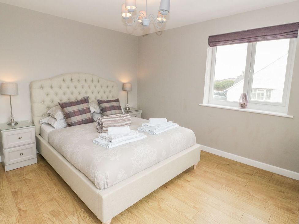 A bedroom with a bed and nightstands at Dunholme