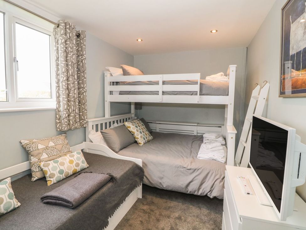 A bedroom with a bunk bed and a double bed at Dunholme