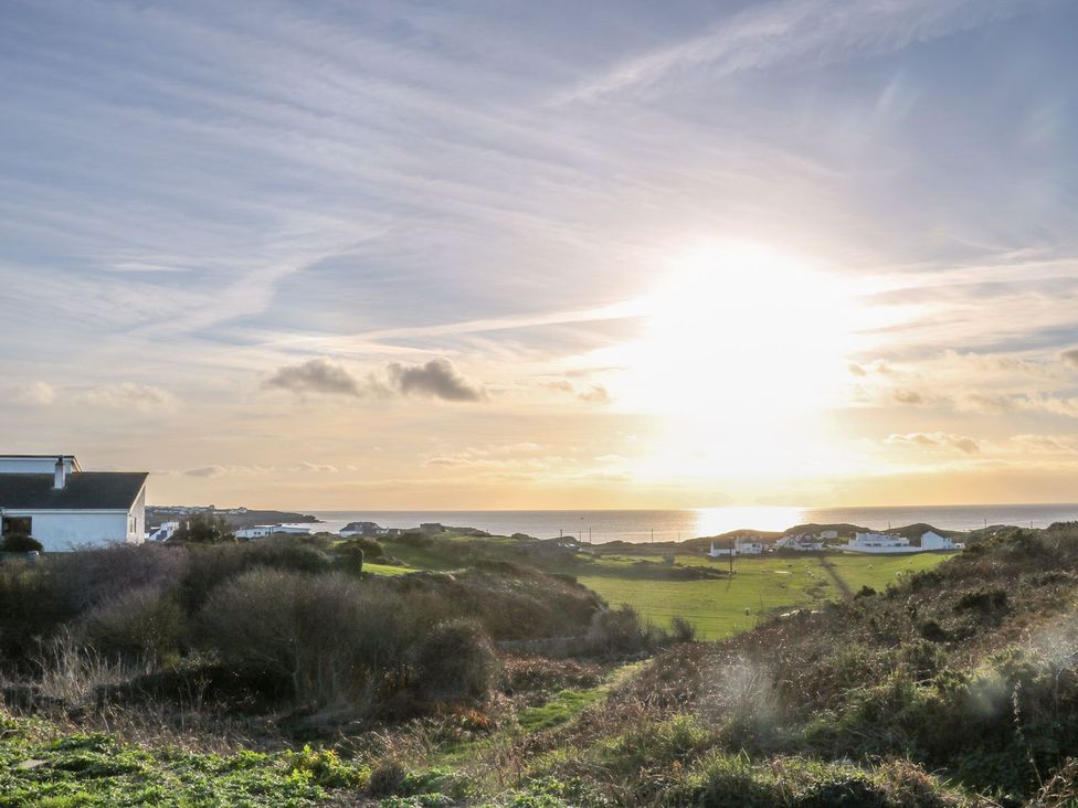 A view of the ocean and hills under a sunlit sky at Dunholme