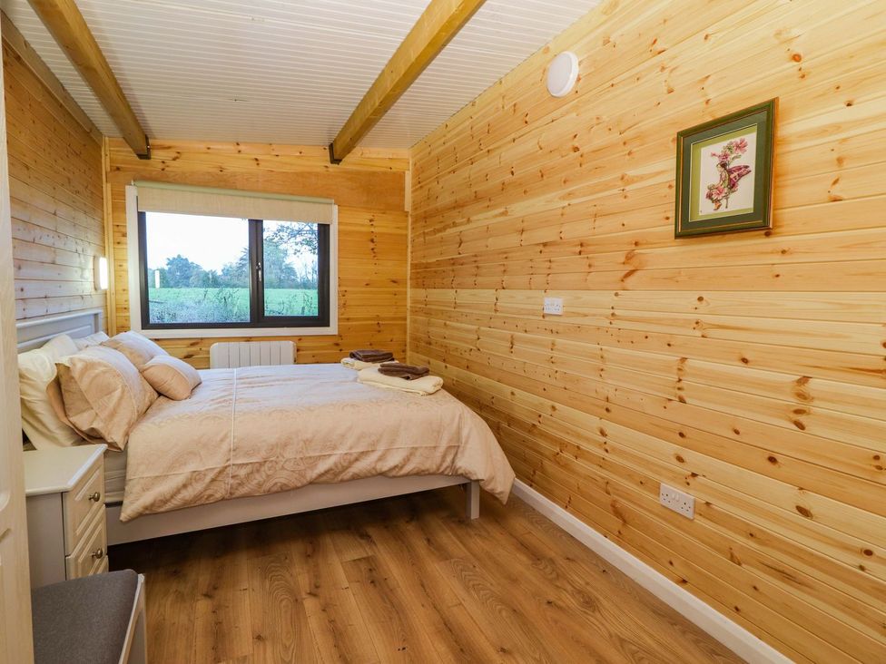 A bedroom with bed and window at Killinure Cottage in Glasson, County Westmeath