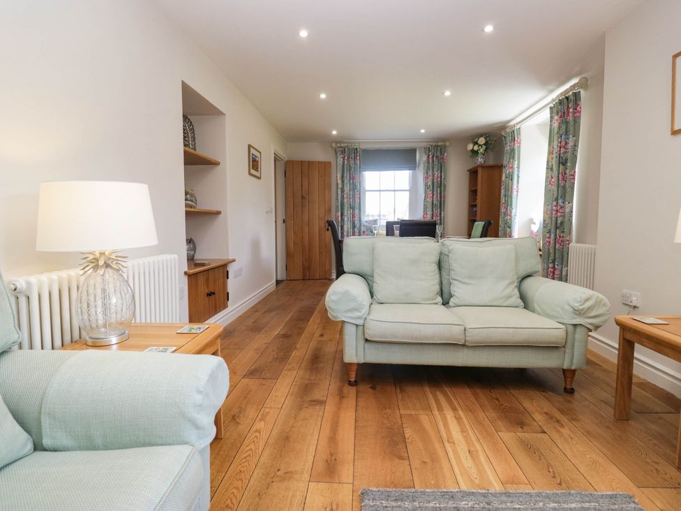 A living room with a sofa and coffee table at Cragg Cottage in Coniston