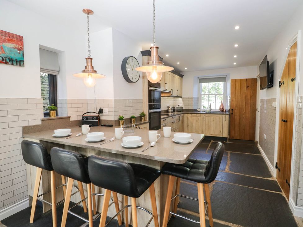 A kitchen with modern appliances at Cragg Cottage in Coniston