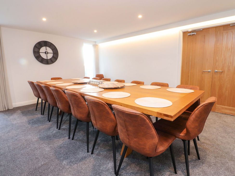 A dining room with a long table and chairs at The Barn in Skipton