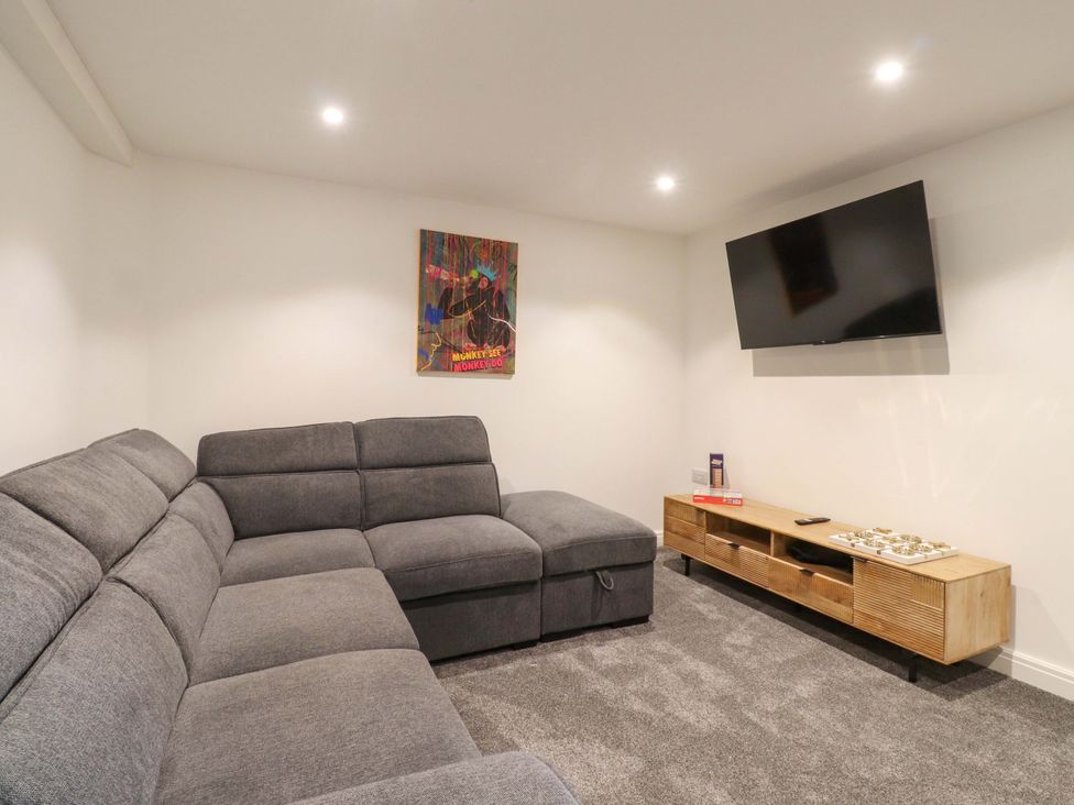 A living room with a sofa and television at The Barn in Skipton