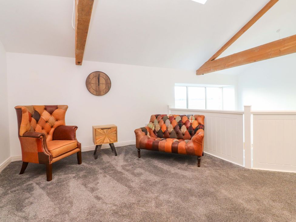 A living room with two upholstered chairs and a side table at The Barn in Skipton