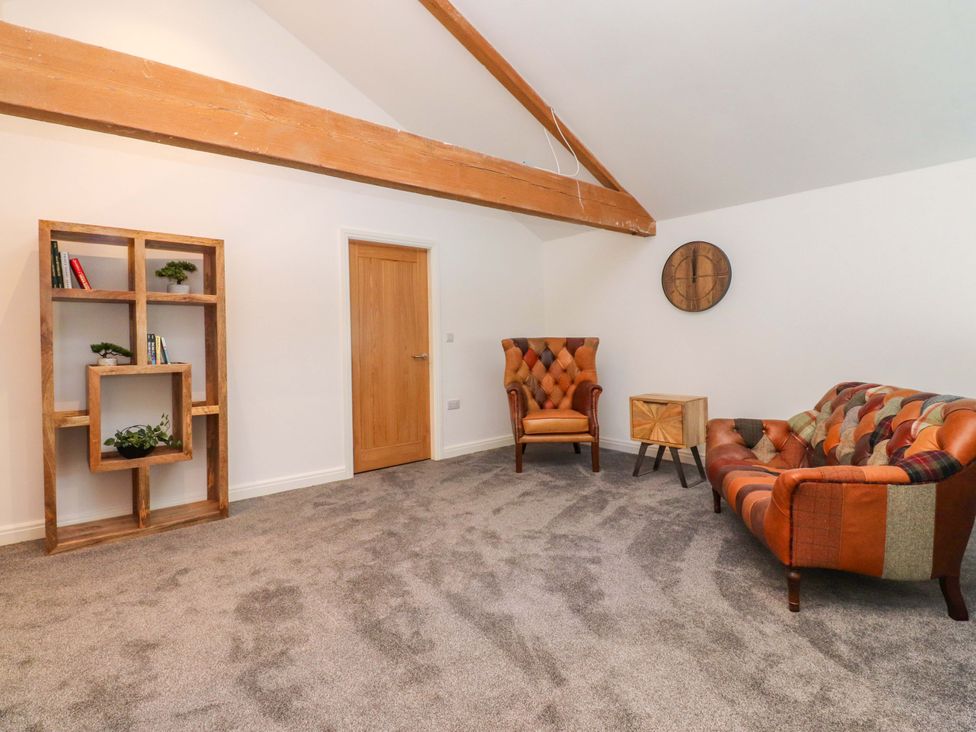 A living room with shelves and furniture at The Barn in Skipton