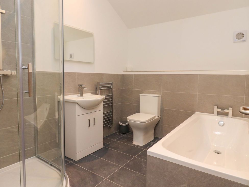 A bathroom with shower, bath, sink, and toilet at The Barn in Skipton