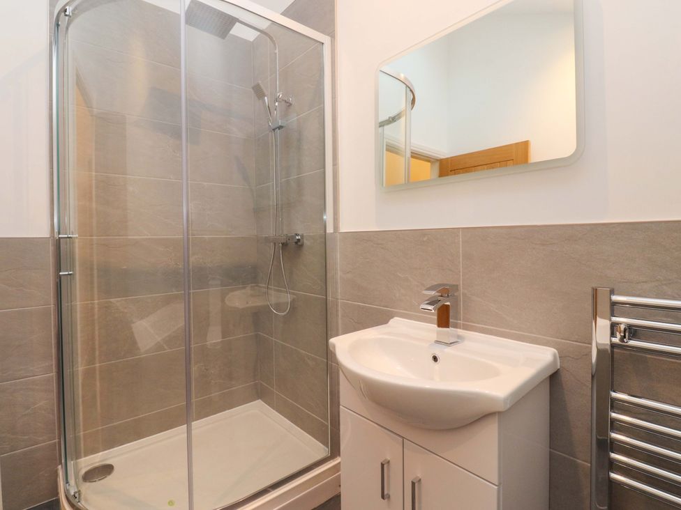 A bathroom with a shower and sink at The Barn in Skipton