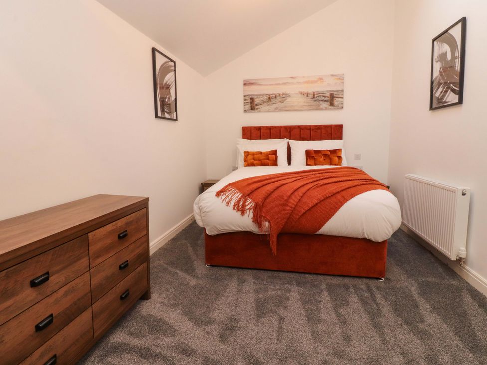 A bedroom with a bed and dresser at The Barn in Skipton