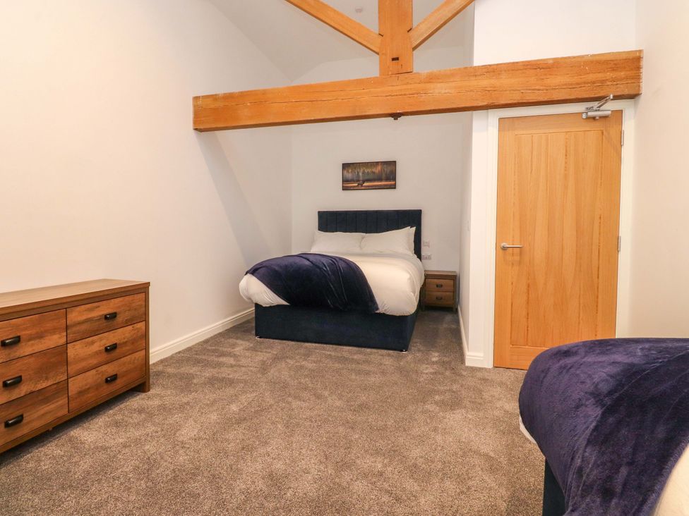 A bedroom with a bed and a drawer at The Barn in Skipton