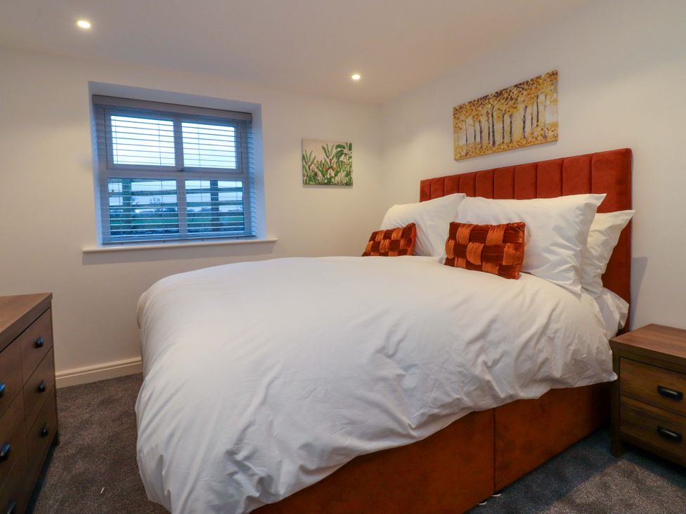 A bedroom with a bed and bedside table at The Barn in Skipton