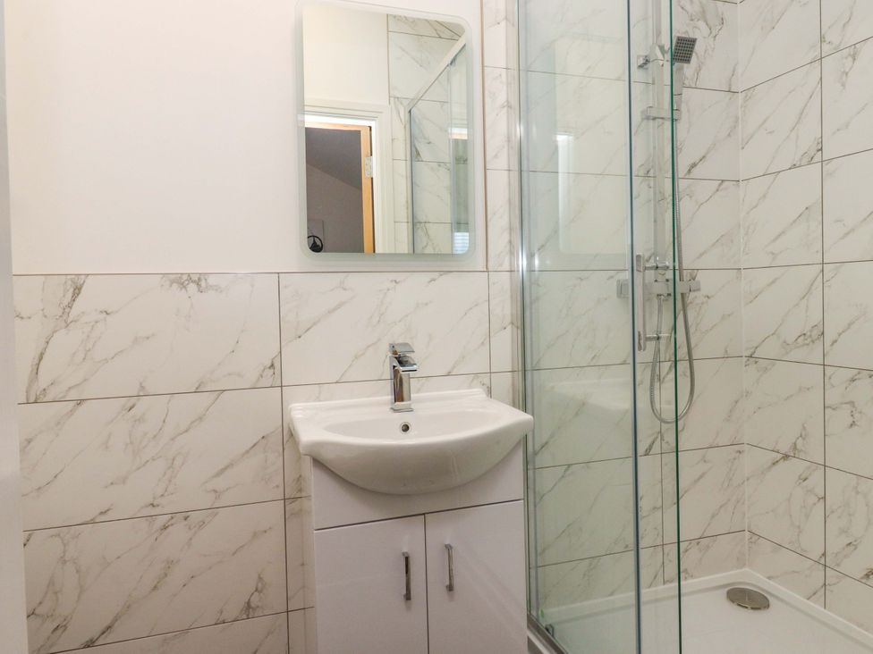 A bathroom with a sink and shower at The Barn in Skipton