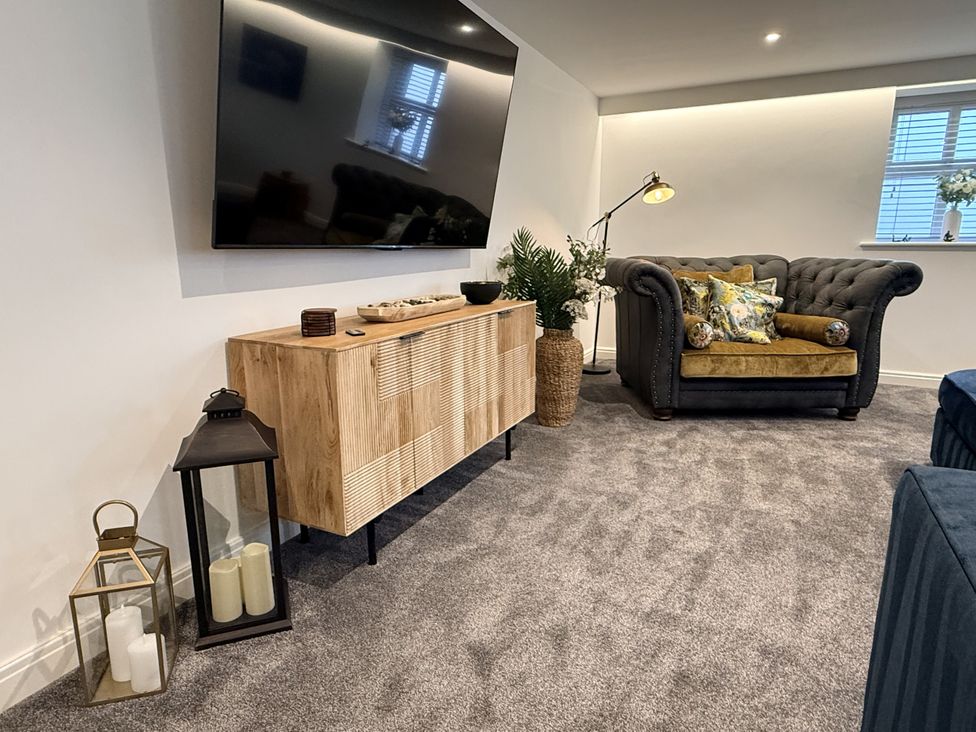 A living room with a television and sofa at The Barn in Wigglesworth near Settle