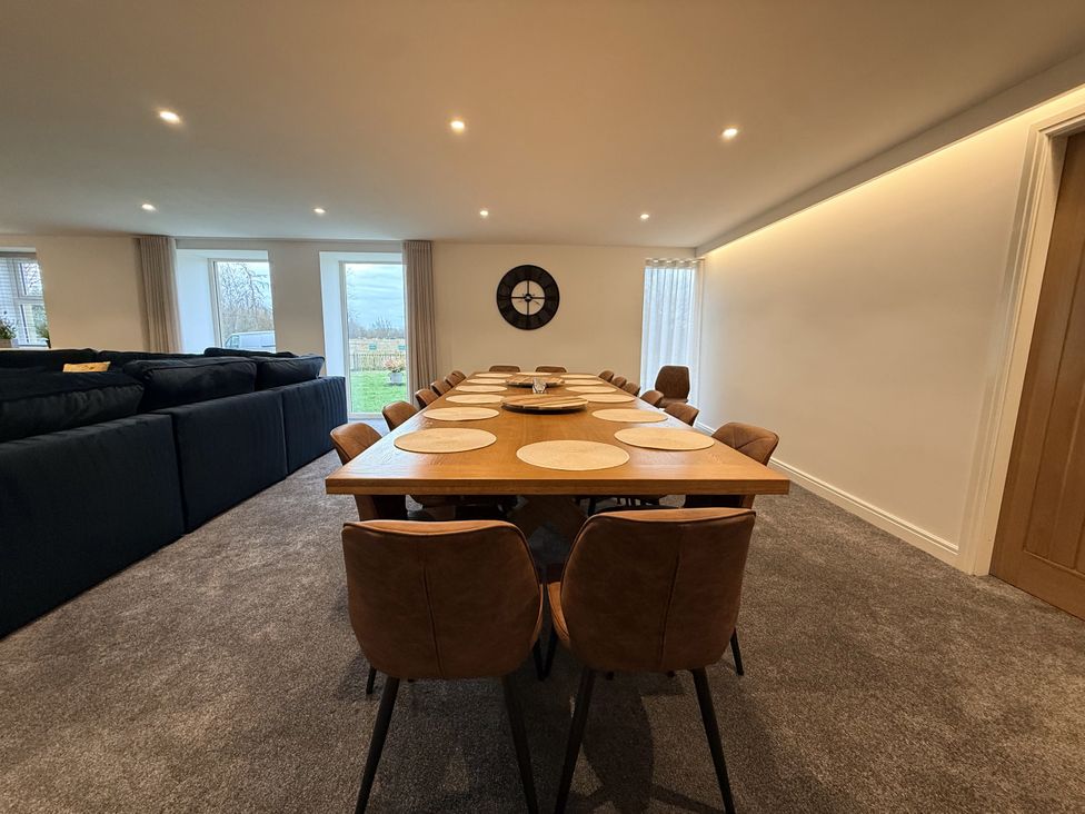 A dining room with a wooden table and chairs at The Barn in Wigglesworth near Settle