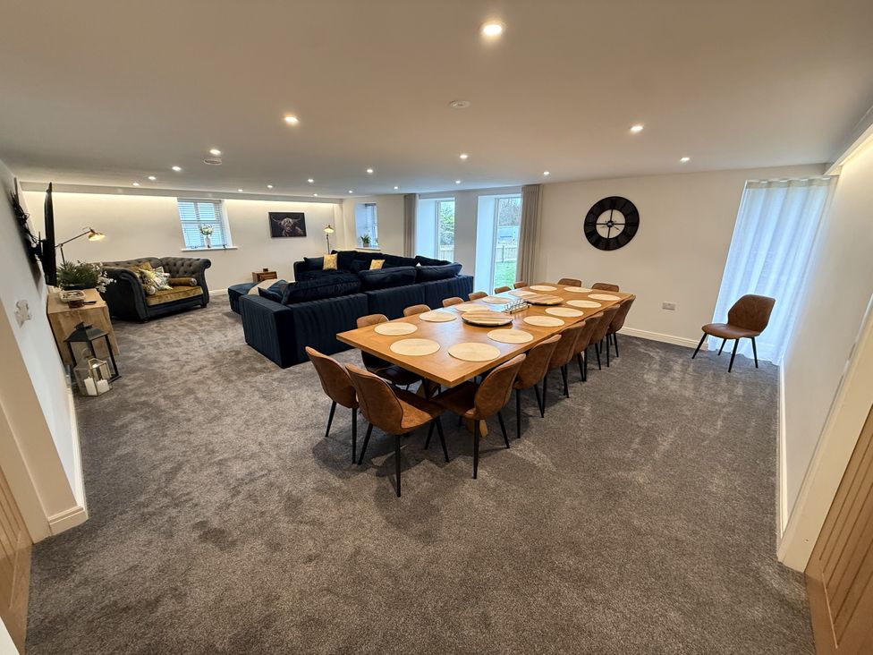 A dining area with a table and chairs in a living room at The Barn in Wigglesworth near Settle