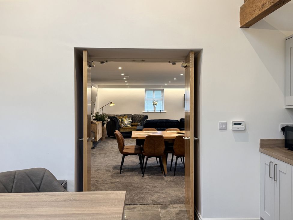 A living room with a table and chairs visible at The Barn in Wigglesworth near Settle
