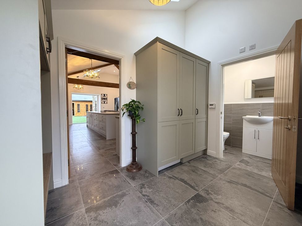 A hallway with storage cabinets and a bathroom at The Barn in Wigglesworth near Settle