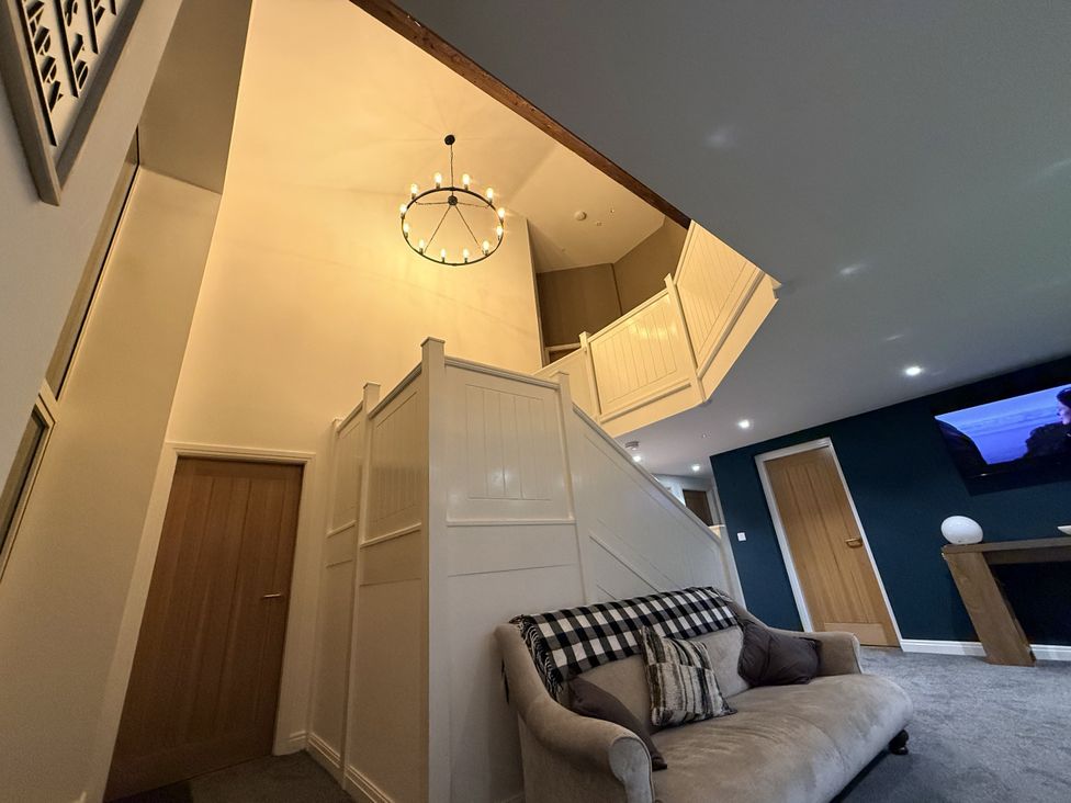 A staircase and sofa in a hallway at The Barn Wigglesworth near Settle