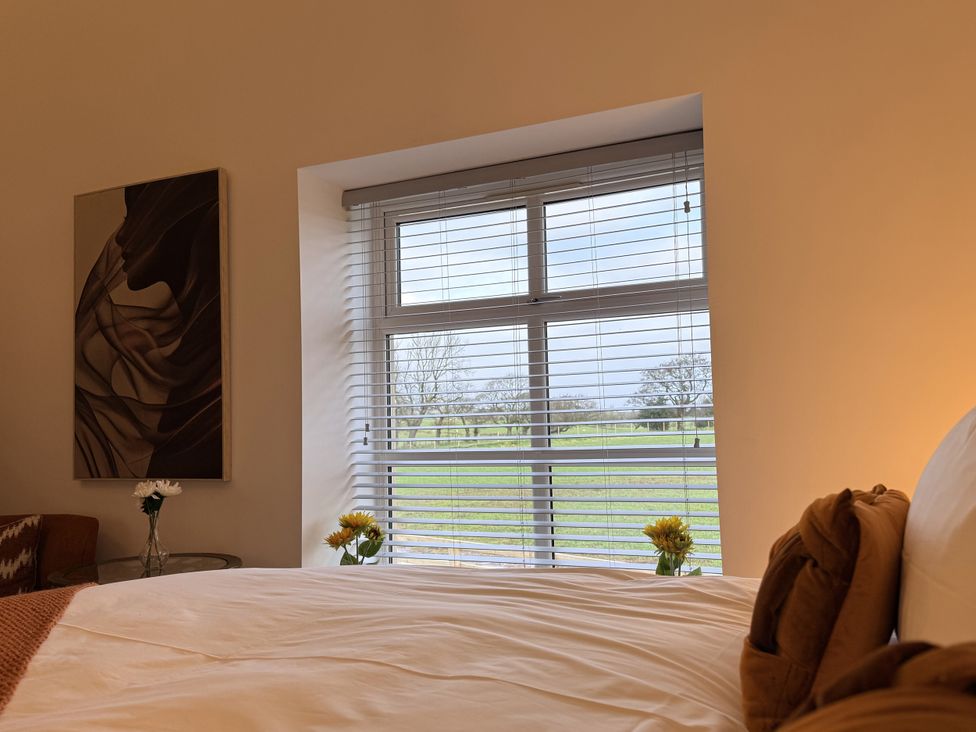 A bedroom with a bed and window view at The Barn in Wigglesworth near Settle