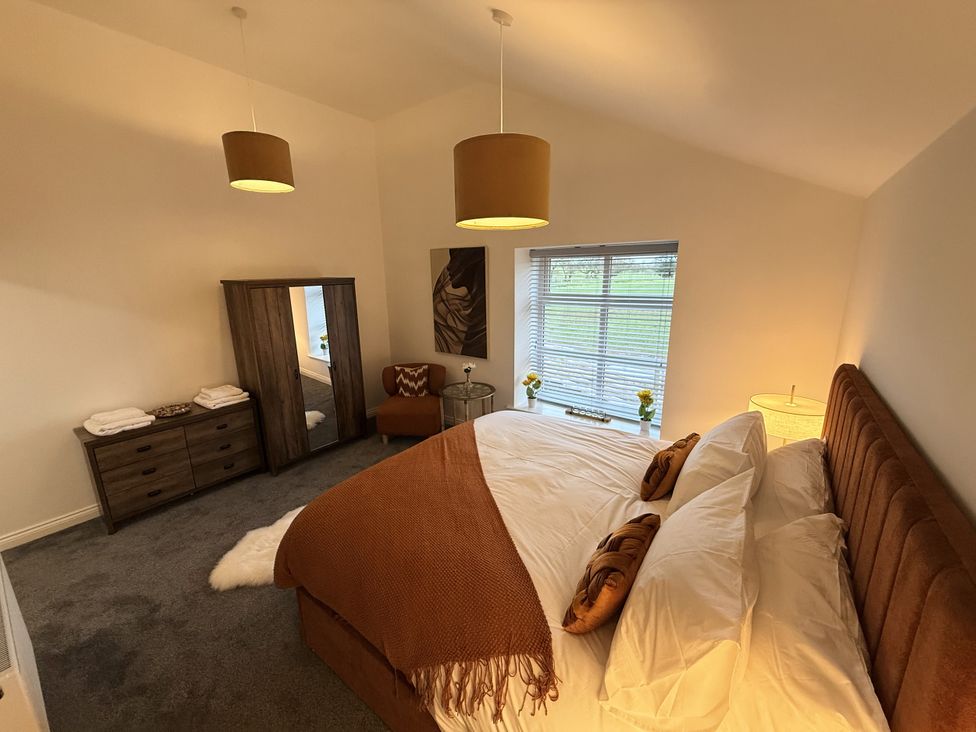 A bedroom with a bed and wardrobe at The Barn in Wigglesworth near Settle