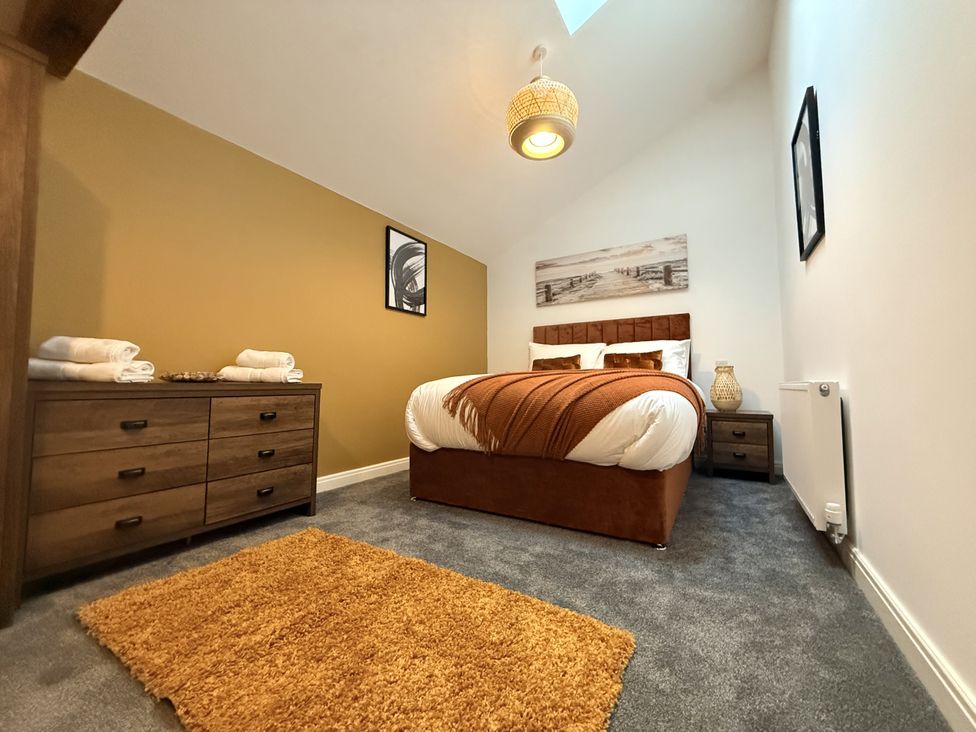 A bedroom with a bed and nightstand at The Barn in Wigglesworth near Settle