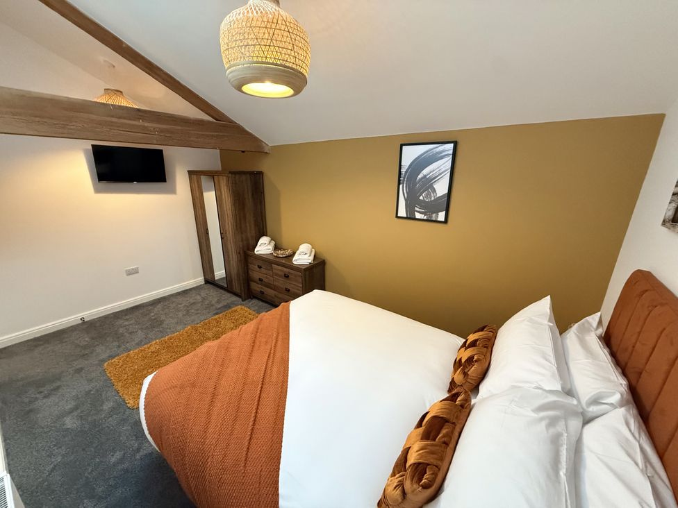 A bedroom with a bed and wardrobe at The Barn in Wigglesworth near Settle